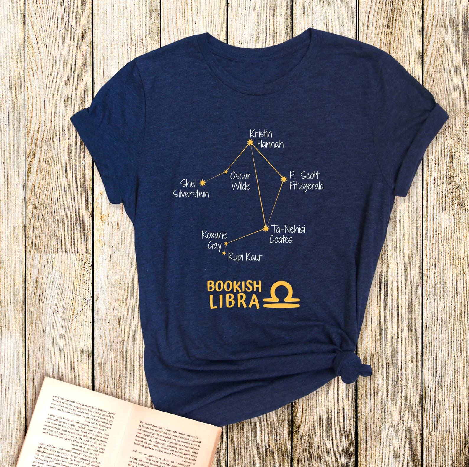 A dark blue t-shirt with the libra zodiac constellation. It features the names of famous libra authors.