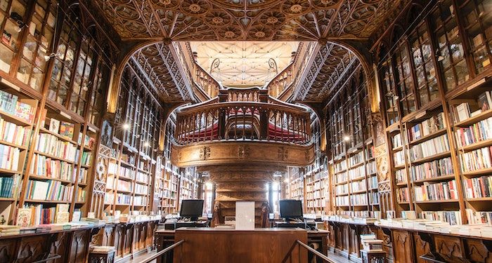 a photo of a bookstore with beautiful old architecture and winding stairs