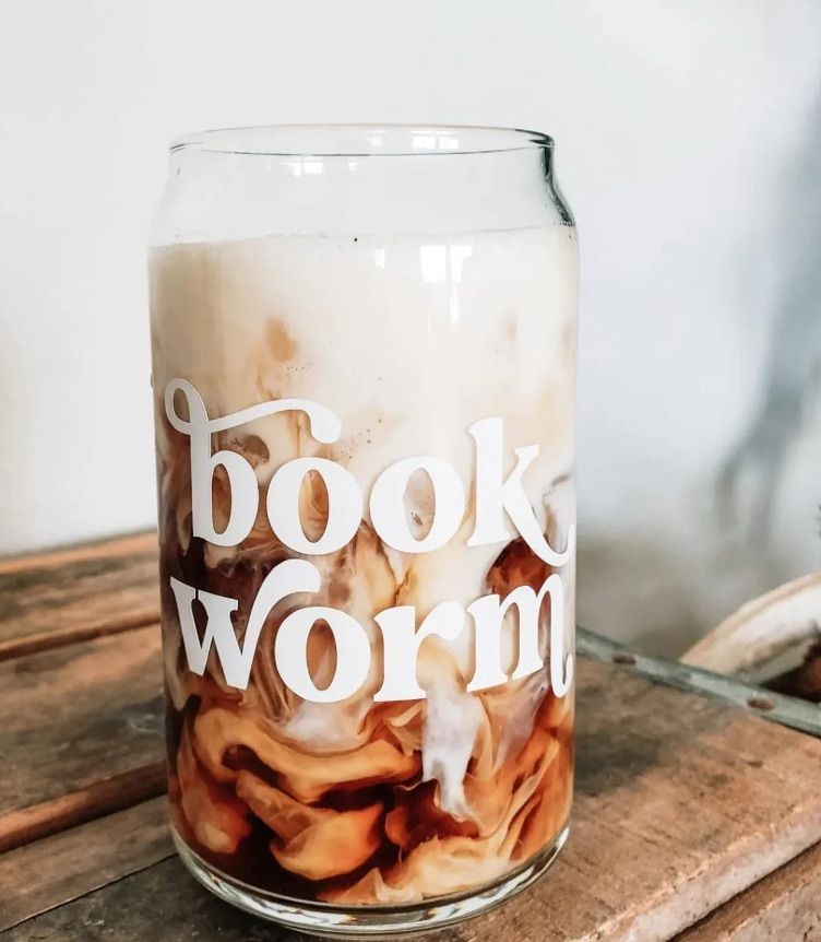 Image of a glass with the words "book worm" in white. 