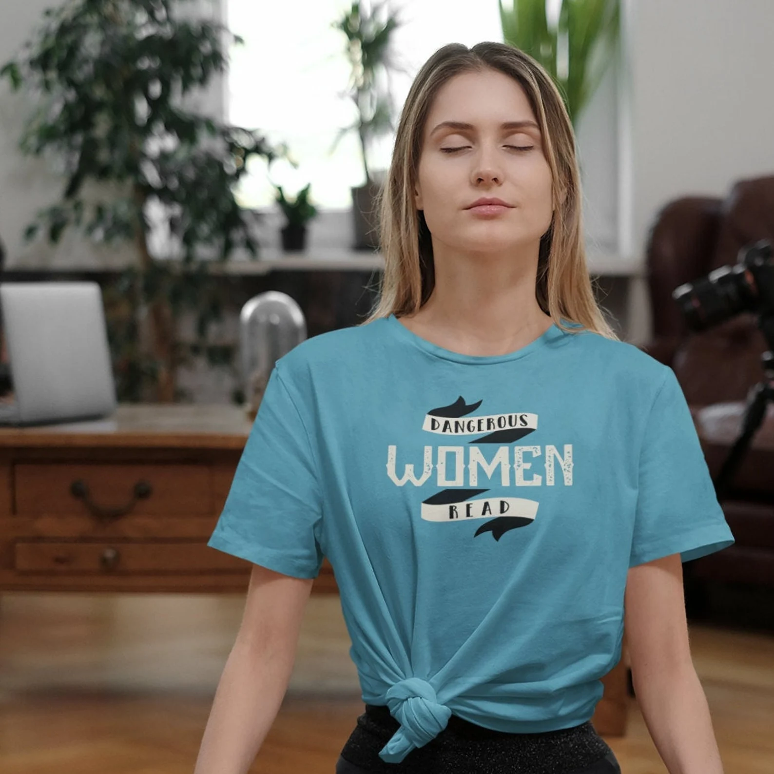 an image of a blonde woman wearing a blue t-shirt that reads "Dangerous Women Read"