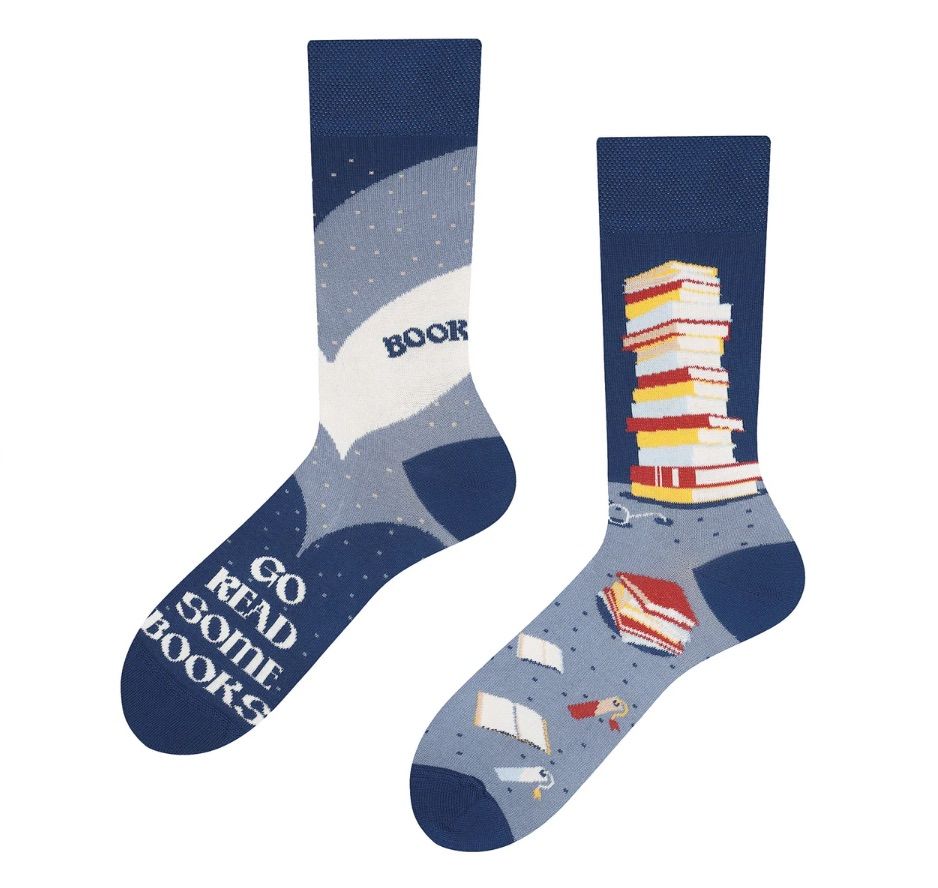 Image of a pair of blue socks that feature stacks of books. The socks red 