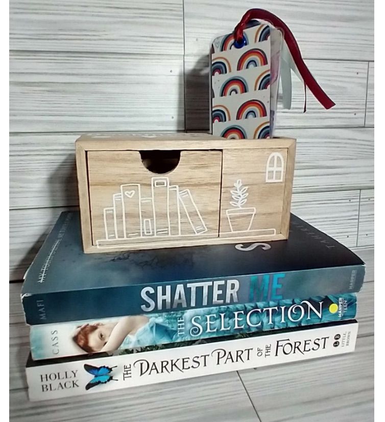 Image of a small drawer on top of a book stack.