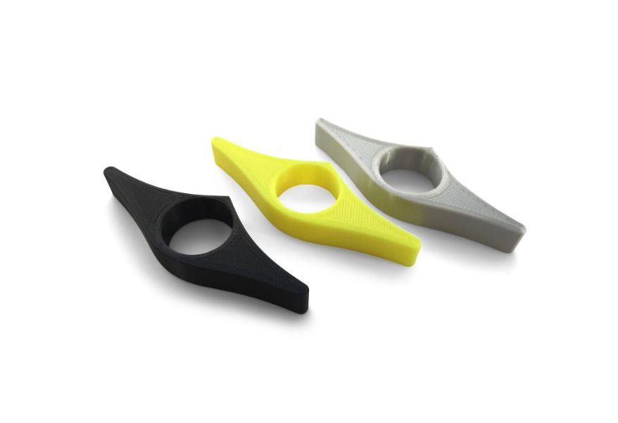 Image of three book page holders in black, yellow, and gray.