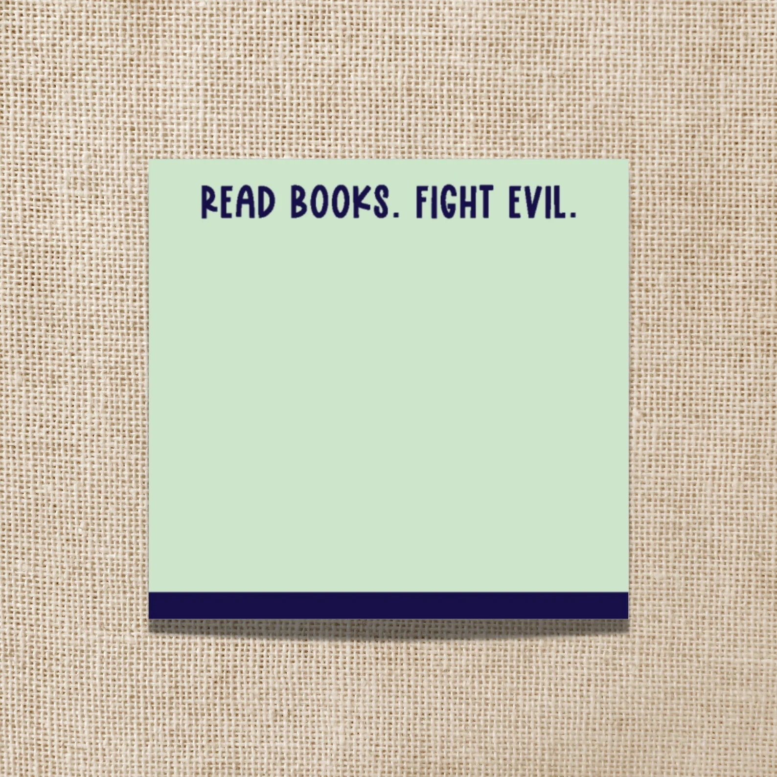 green sticky note pad that reads "Read books, fight evil" at the top