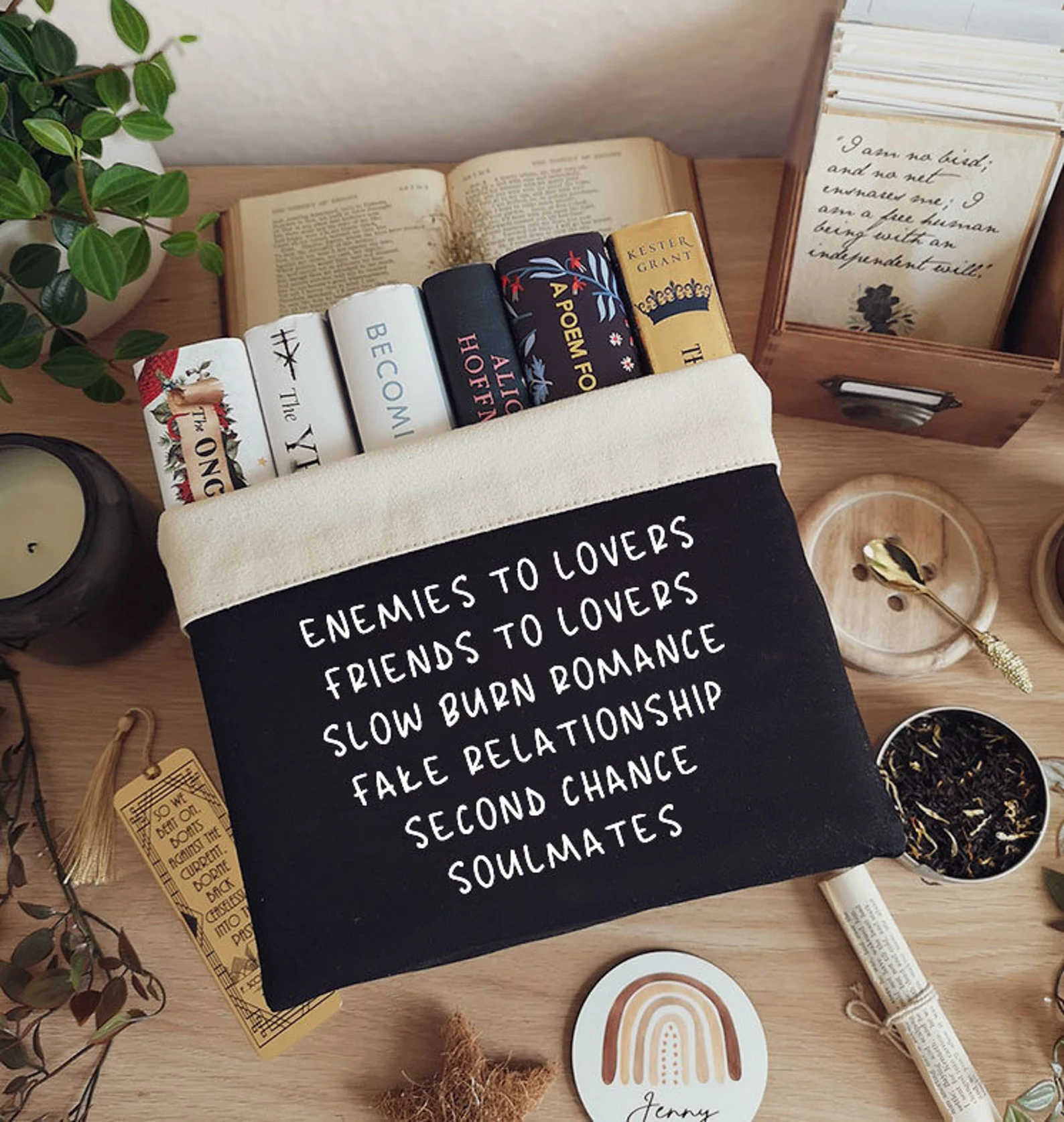 Photo of a black book basket that has different romance tropes written on the front