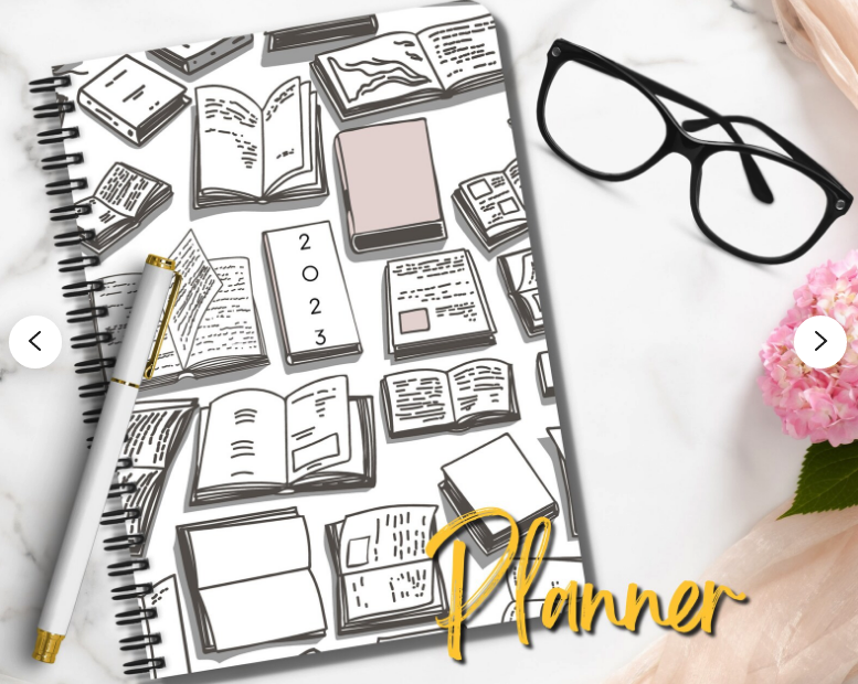 cover of the 2023 planner next to a pen and a pair of glasses