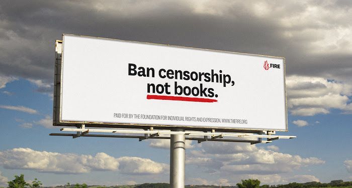 a white billboard that says "Ban censorship, not books" against a gray cloudy sky