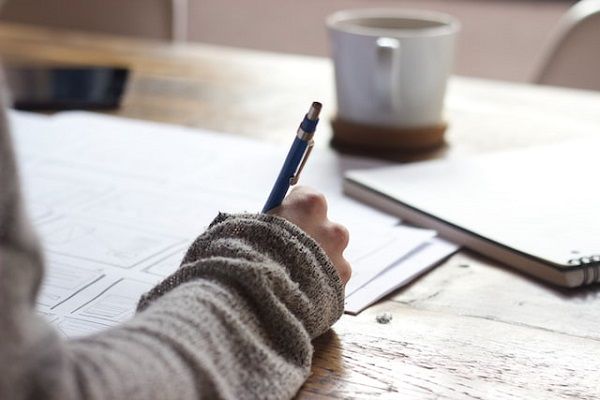 a photo of someone filling out a character sheet