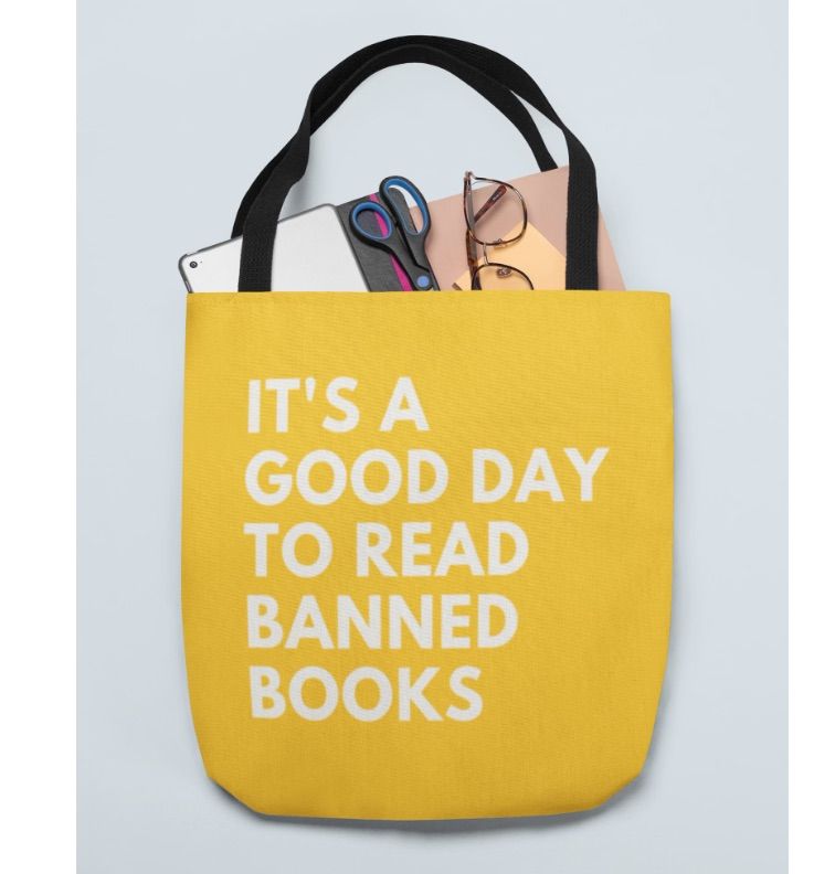 Image of a bright yellow tote bag with white text that says 