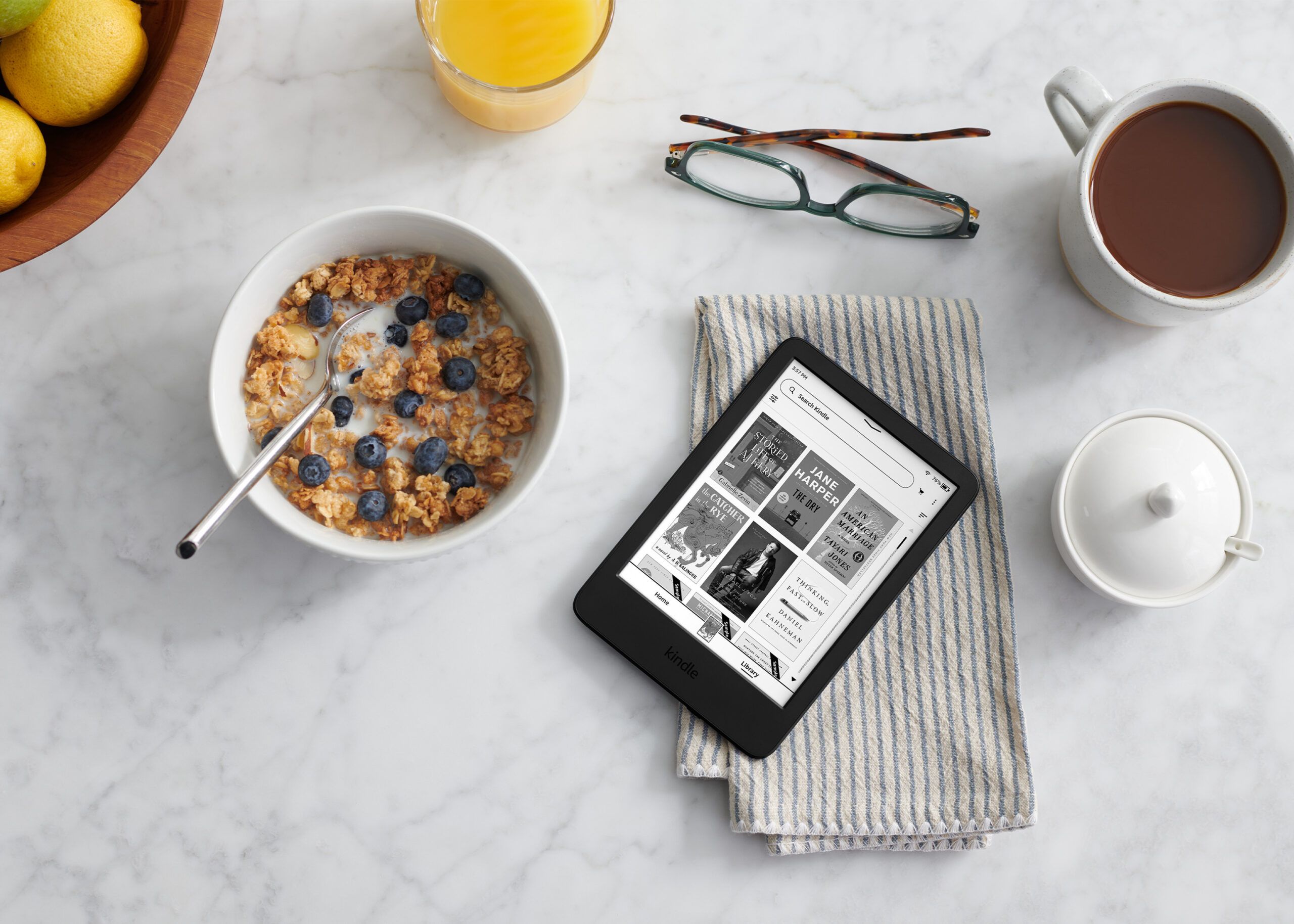 kindle press image of a kindle laying next to a breakfast scene