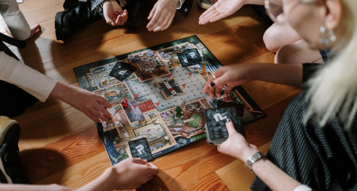 a photo of a group of people playing Clue