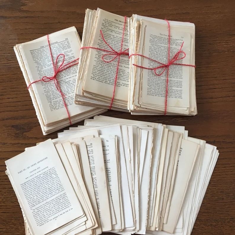 a photo of loose pages from old books, some of them in bundles