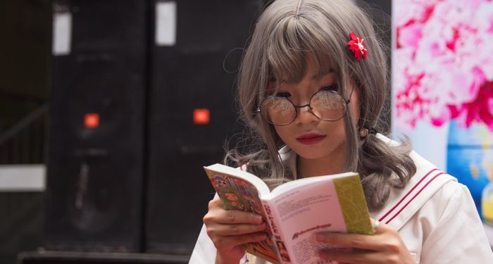Asian woman reading manga