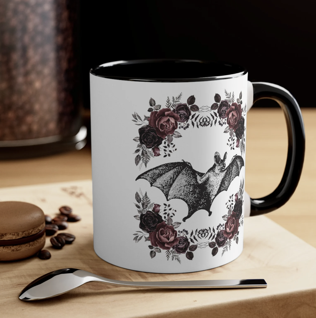 White ceramic mug with a vintage bat print surrounded by Victorian style flowers on each side