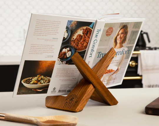 A wooden cookbook stand is displayed on a kitchen counter