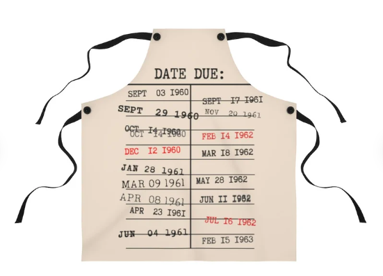 A cream colored apron screen printed to look like a library due date card with various stamped dates