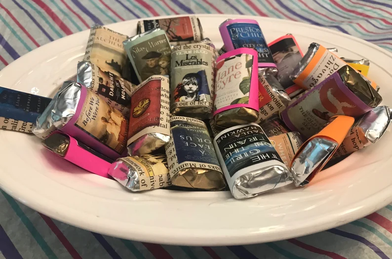 a photo of a bowl of small chocolates with book cover wrappers