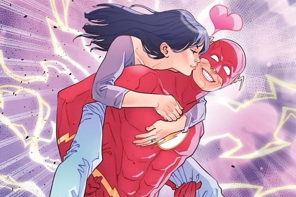 Part of the cover of Flash Annual 2022 #1. Wally is running and carrying Linda piggyback, beaming hugely while she kisses him on the cheek. There's a little pink heart over their heads.