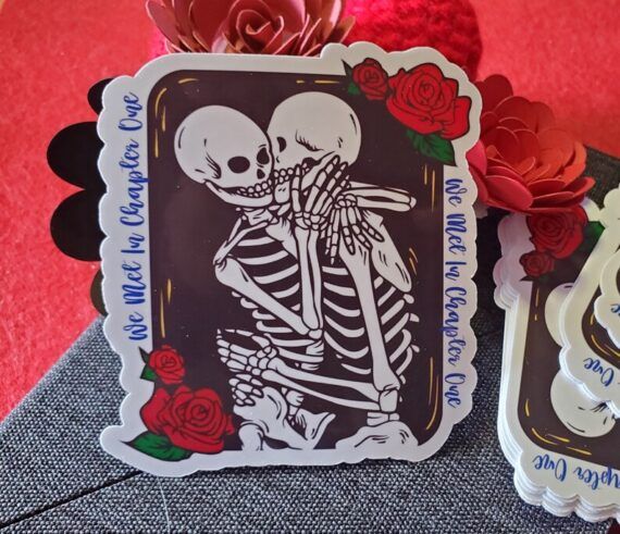 a vinyl sticker with two skeletons embracing 
