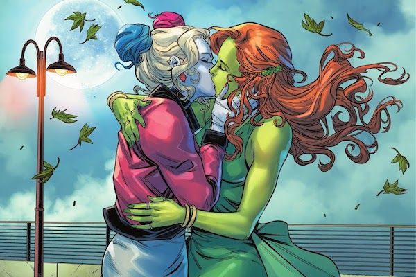 A panel from Harley Quinn #10. Harley and Ivy are kissing on a boardwalk with leaves blowing past them.