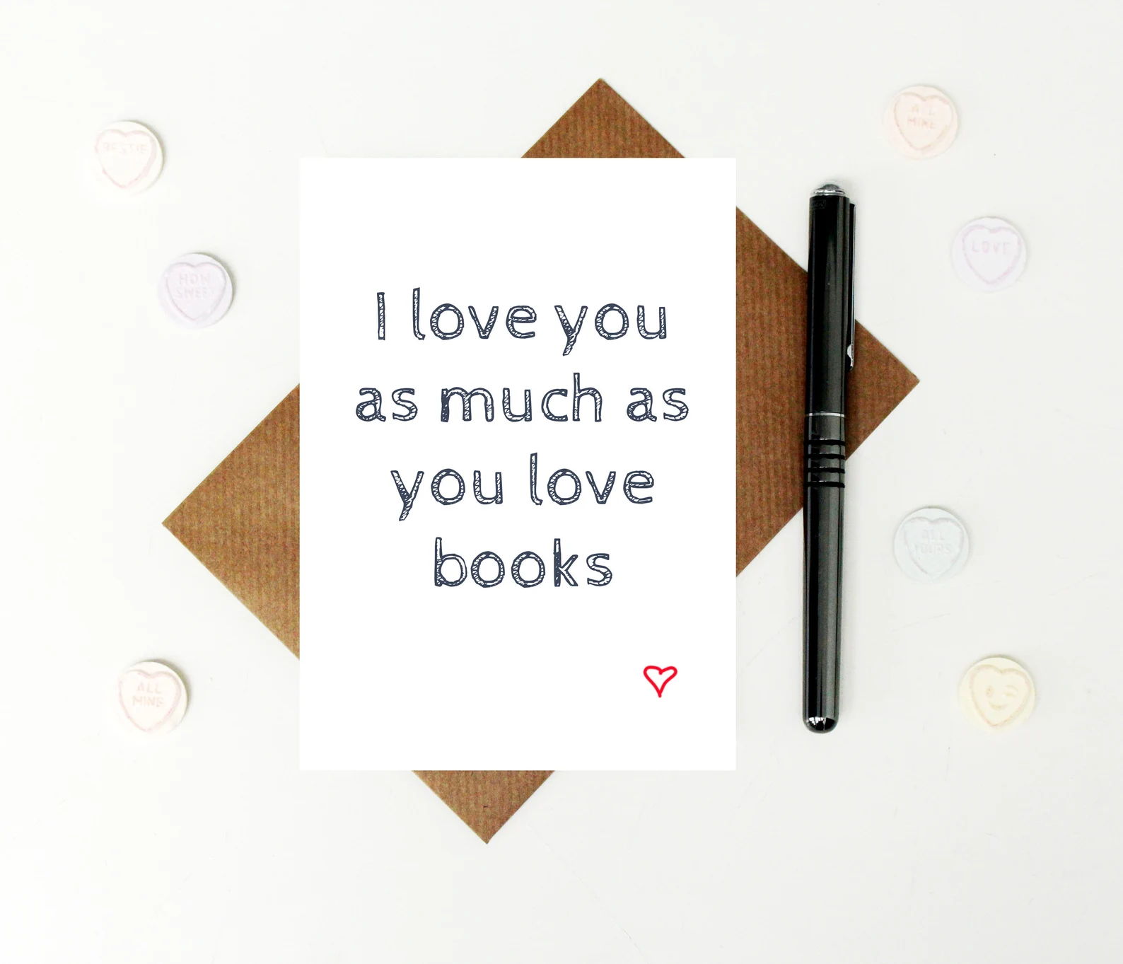 a white card that simply reads "I love you as much as you love books"
