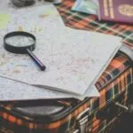Image of a suitcase with magnifying glass and map