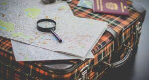 Image of a suitcase with magnifying glass and map