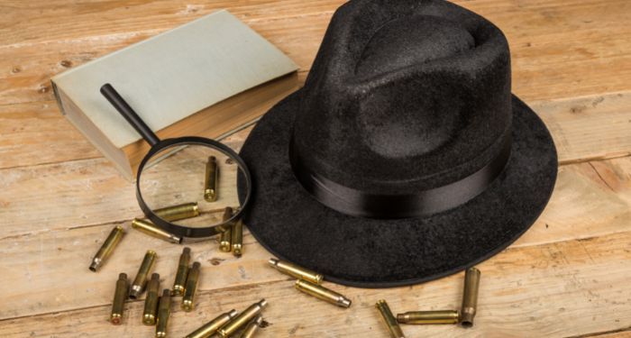 Image of a detective hat, book, magnifying glass, and bullets
