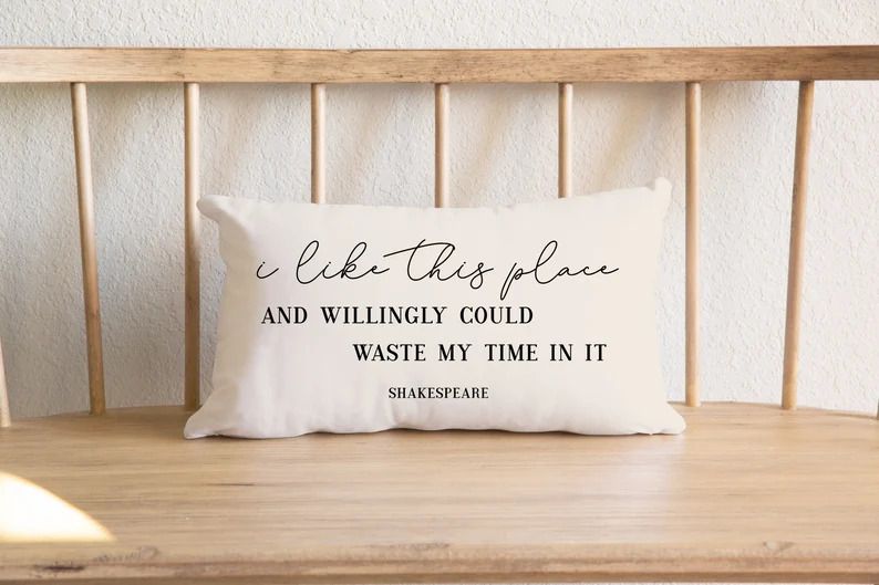 Photo of a rectangular white pillow with the quote Ï like this place and willingly would waste my time in it"by Shakespeare.
