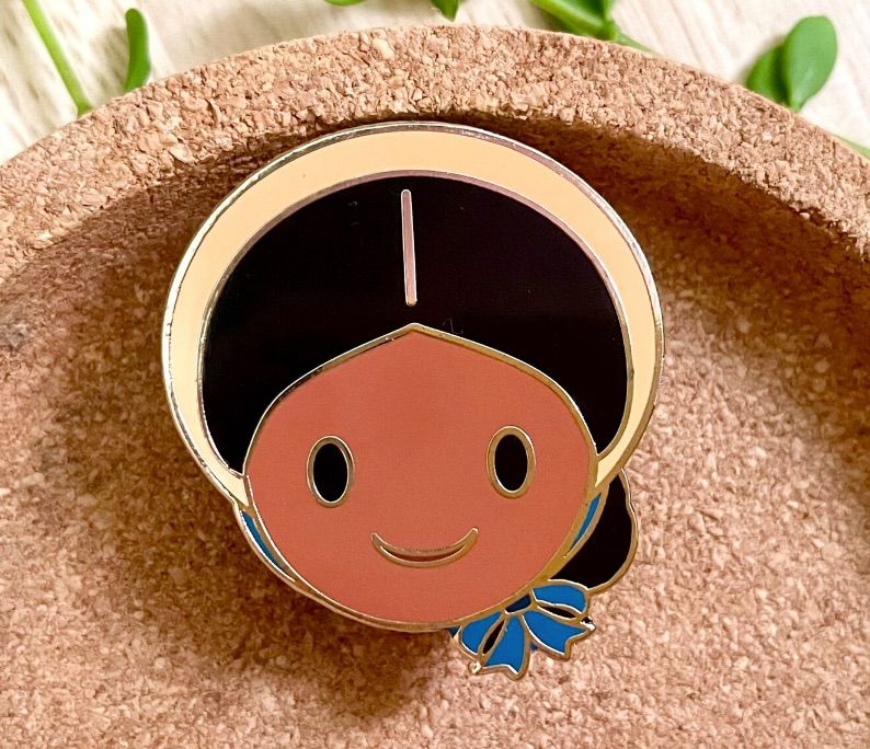 Image of an enamel pin bearing Addy Walker's face