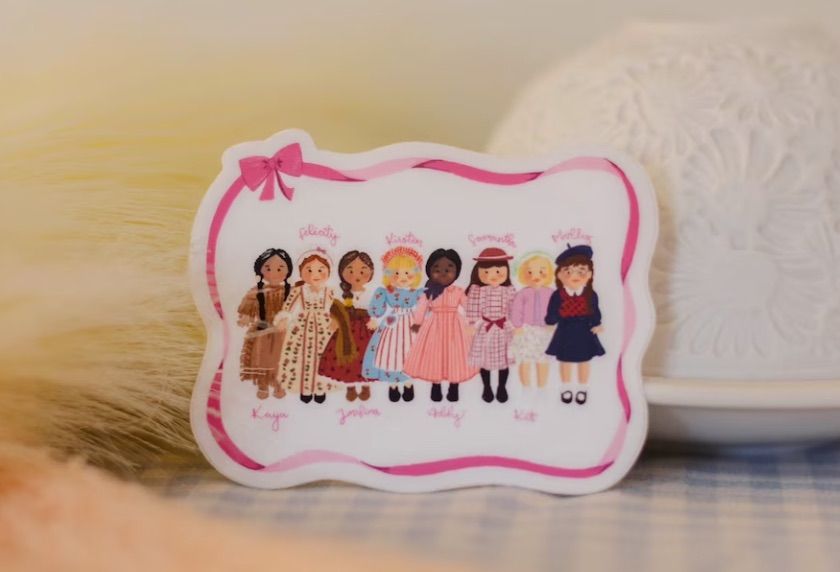 Image of a sticker featuring several American Girls. 