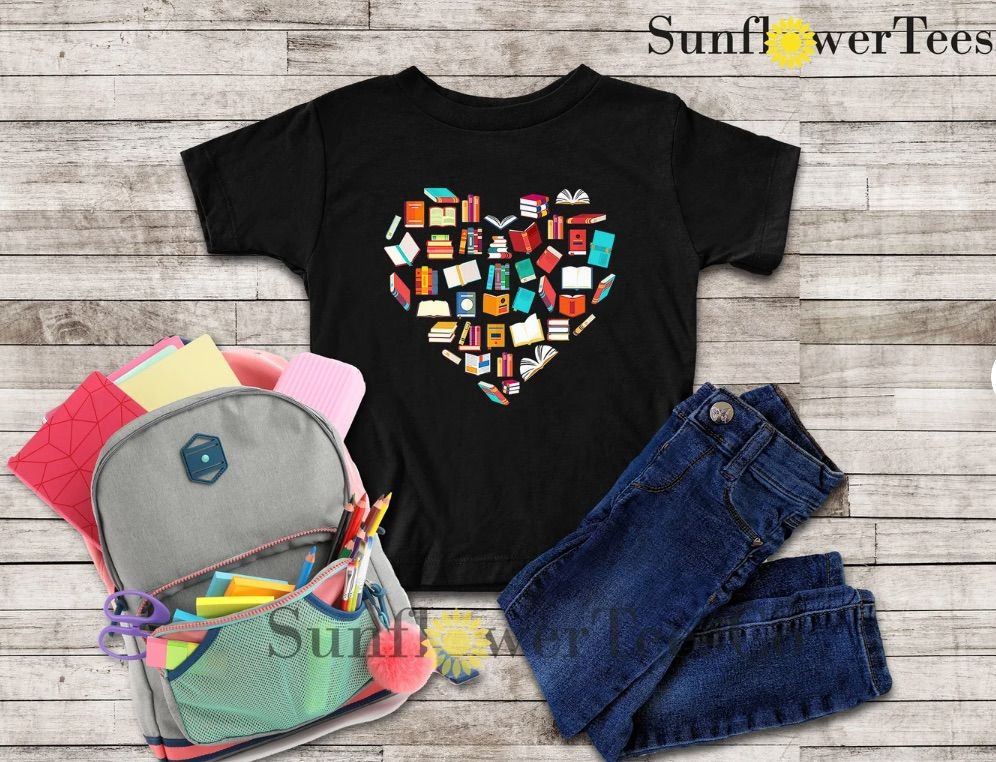 Image of a black tee with colorful books in the shape of a heart. 