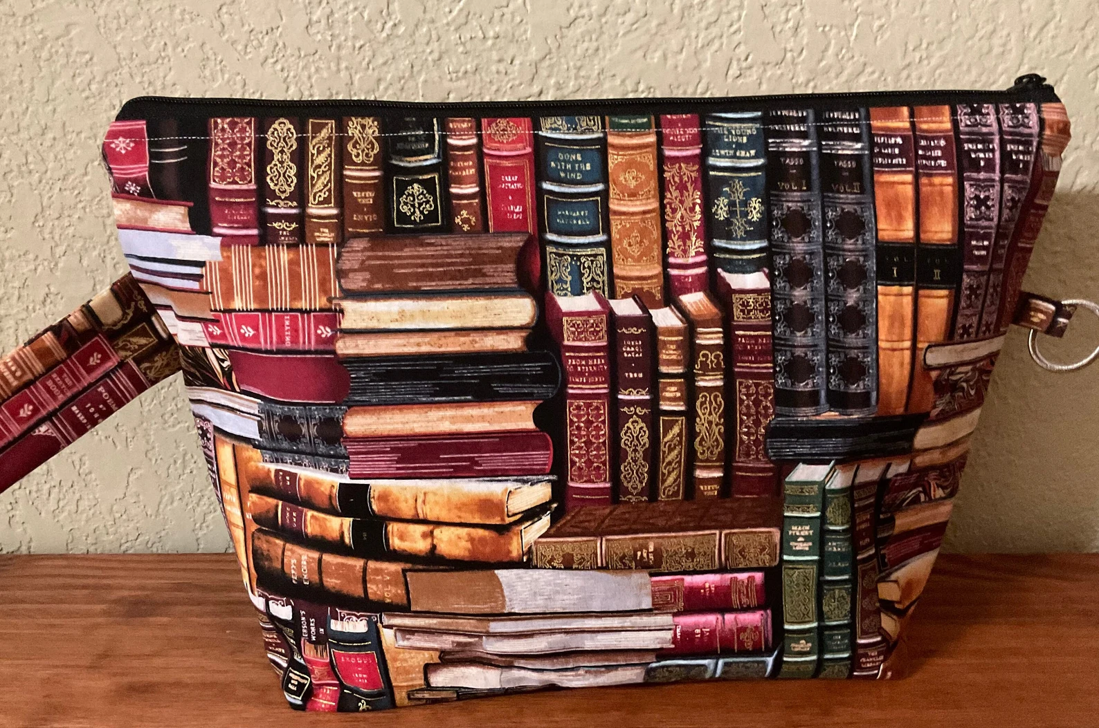 a small cotton project bag with a zipper in an old antique book print