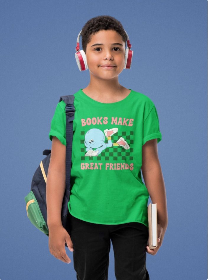 a boy with brown skin wearing a green shirt that has a retro design and font reading "books make great friends."
