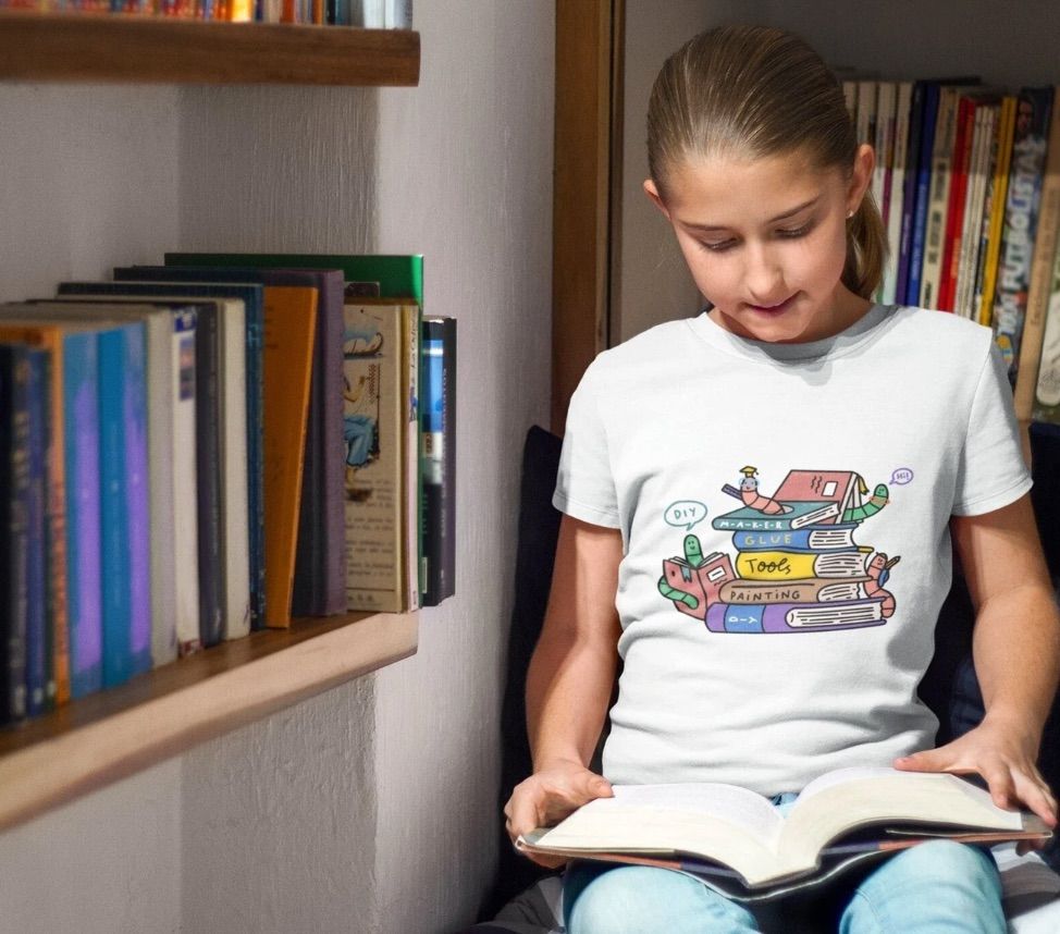 Image of a white girl in a white t-shirt. The shirt has several worms crawling around books. 