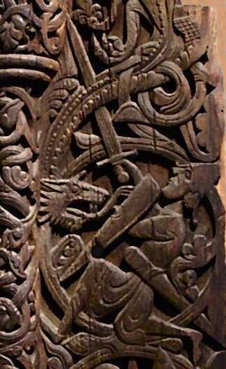 wood carving into a portal plank outside the Hylestad Stave Church in Norway, dating back to the 12th century. Depicts FAfnir and Sigurd locked in battle, FAfnir is wrapped around Sigurnd as Sigurd thrusts his sword into Fafnir's heart