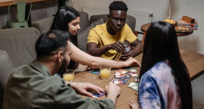 group of friends playing a card game