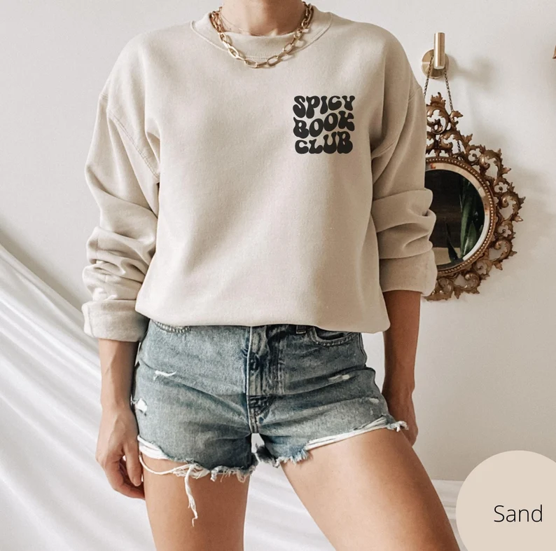 Sand colored sweatshirt with black text reading Spicy book club