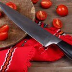 Image of a knife with chopped tomatoes