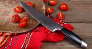 Image of a knife with chopped tomatoes