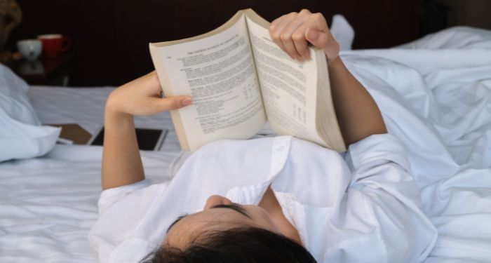 Image of woman reading in bed