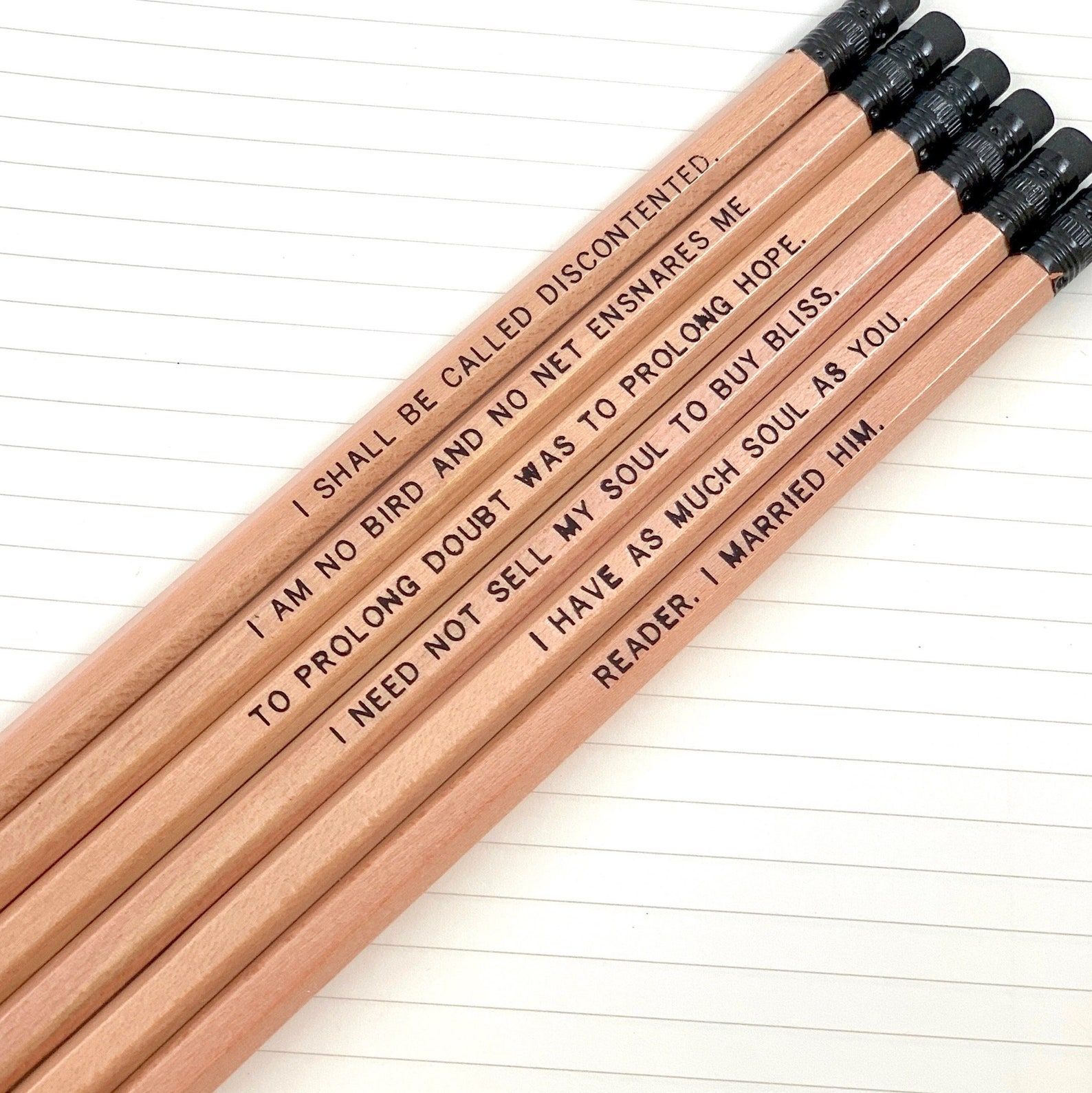 natural wood colored pencils, each printed with a quote from Jane Eyre like "Reader, I Married Him."