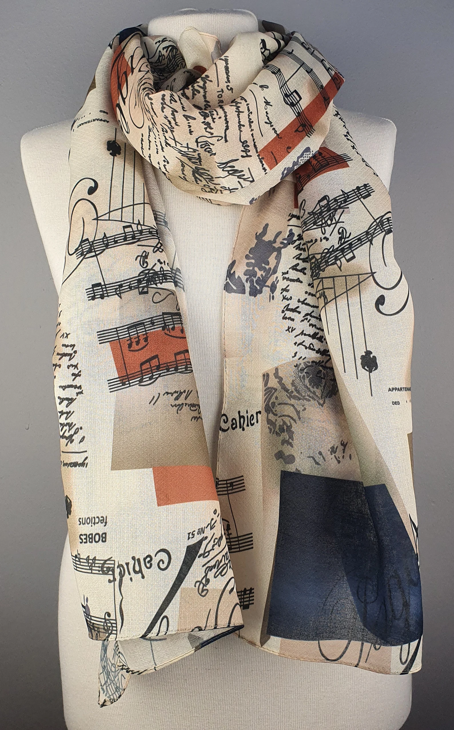 Picture of scarf with musical notes and book text