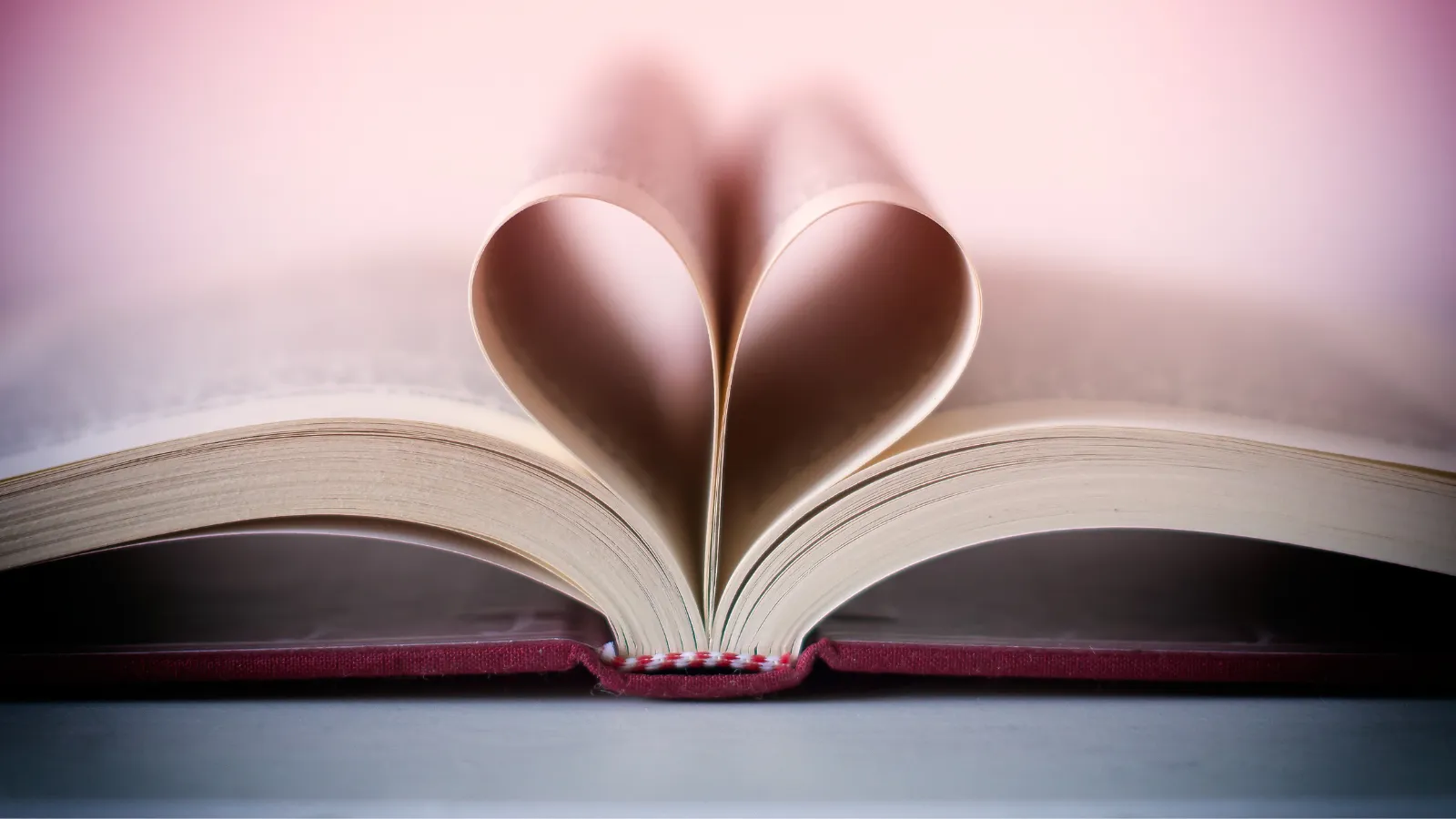 a photo of a book with the pages folded to make a heart