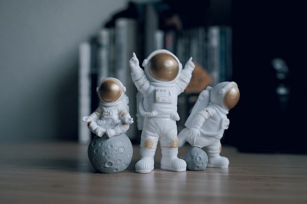 three white and gold astronaut figurines