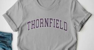 Image of a gray t-shirt with brown text that reads "thornfield."
