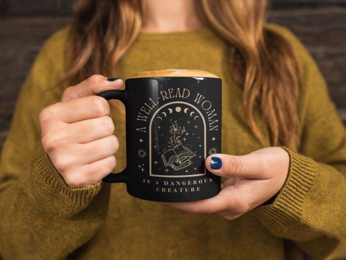 black mug with gold print reading 