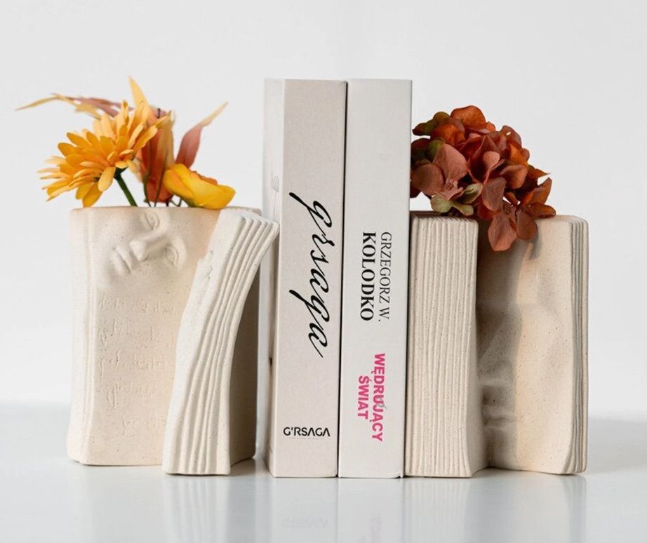 set of book ends that are also vases in the shape of a book.