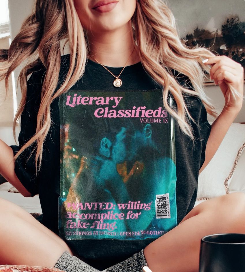 Black t-shirt with "literary classifieds" featuring a kissing couple. It's a fake ad for books about fake dating. 