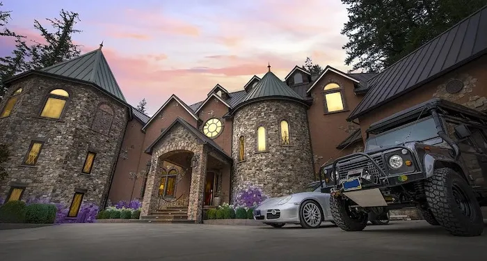 an exterior shot of a huge, castle-like home complete with turrets
